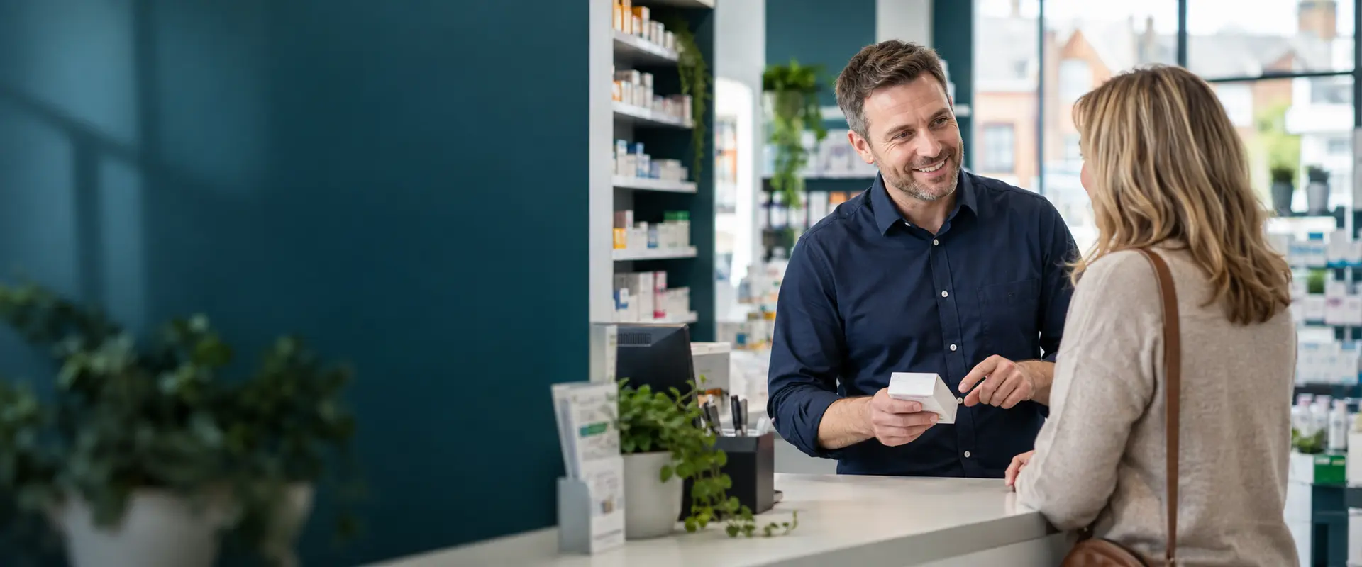 A community pharmacist speaking with a patient
